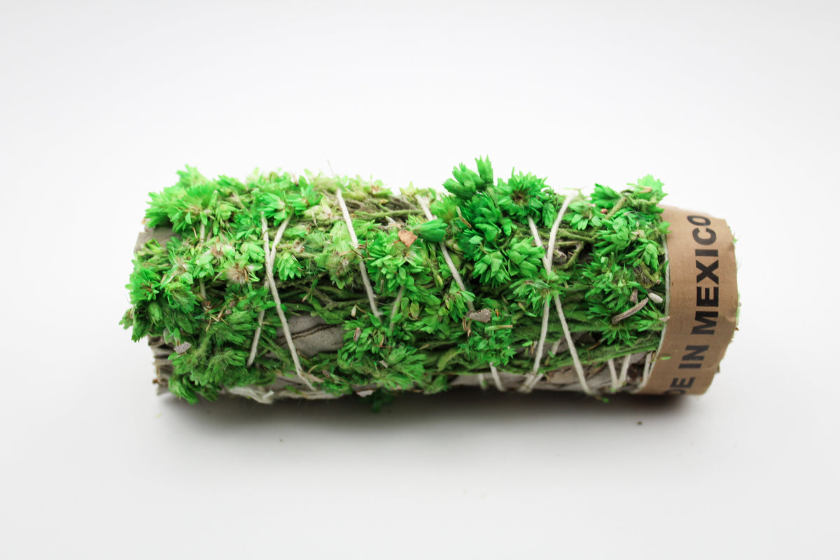A bundle of sage with green flowers attached.