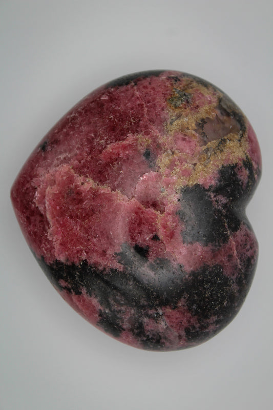 Polished Rhodonite heart.