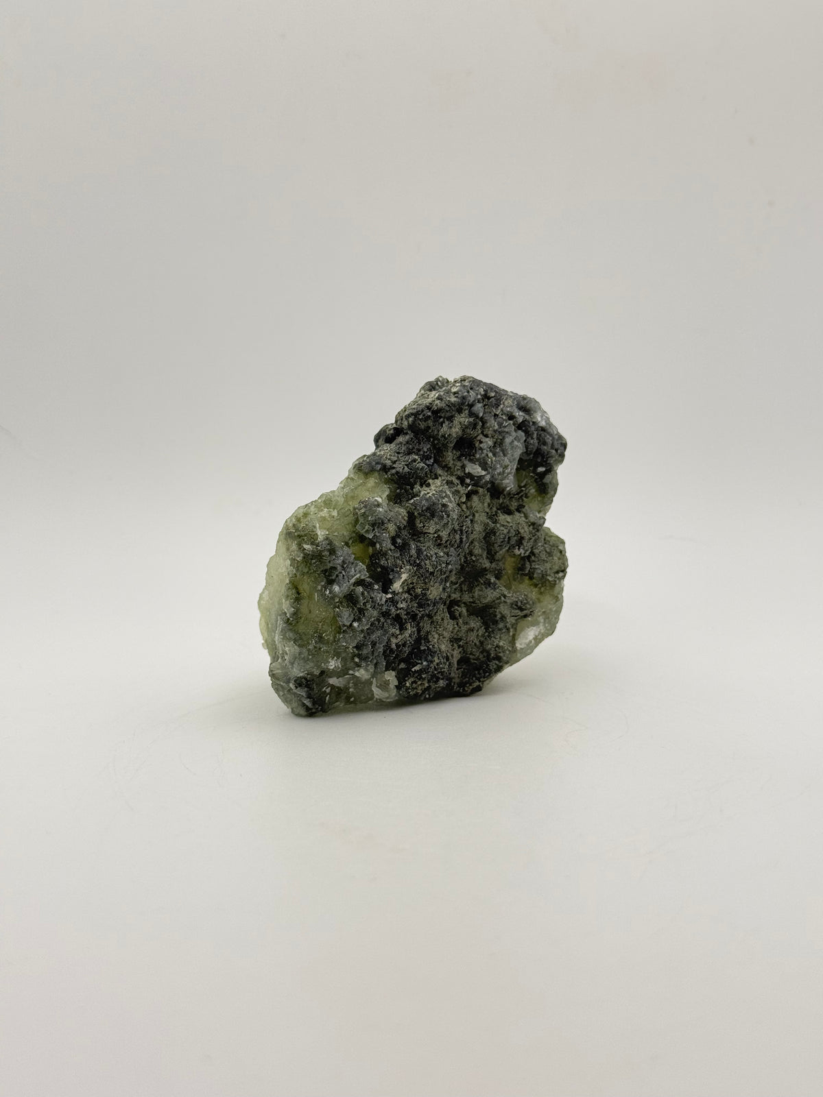 Raw Prehnite specimen with amazing green color.