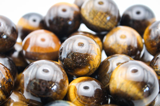 A collection of polished yellow tiger eye spheres.