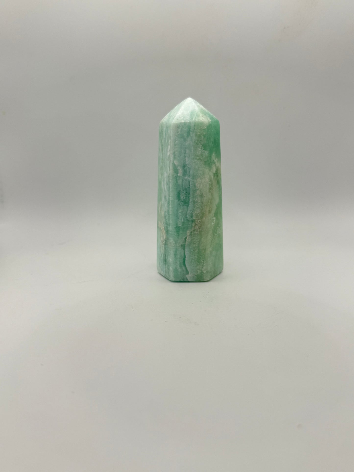 Caribbean Calcite polished six sided tower. A little over 4 inches tall.