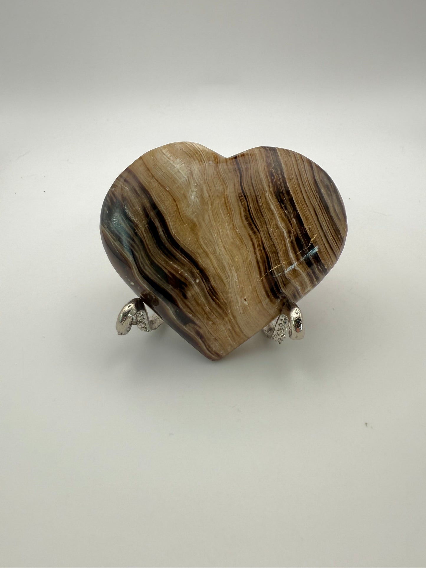 Polished chocolate calcite heart shaped crystal.