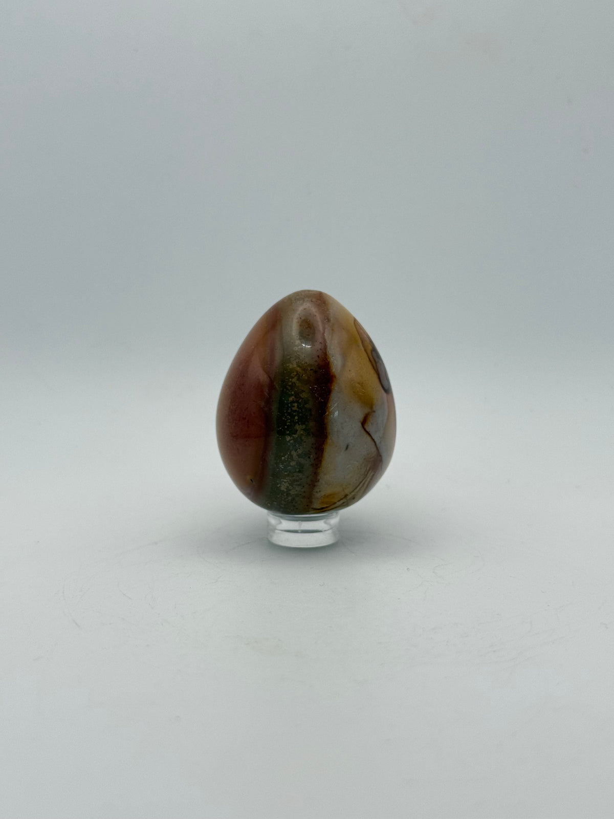 Polished polychrome jasper shaped into an egg.