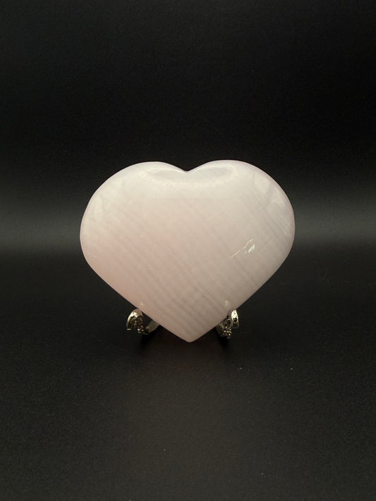 Polished pink calcite heart. Pink calcite glows under uv light.