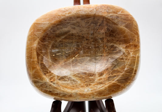 Polished yellow moonstone in the shape of a bowl.