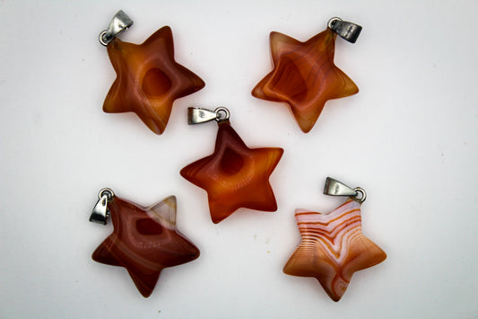 A close-up image of a carnelian star pendant.