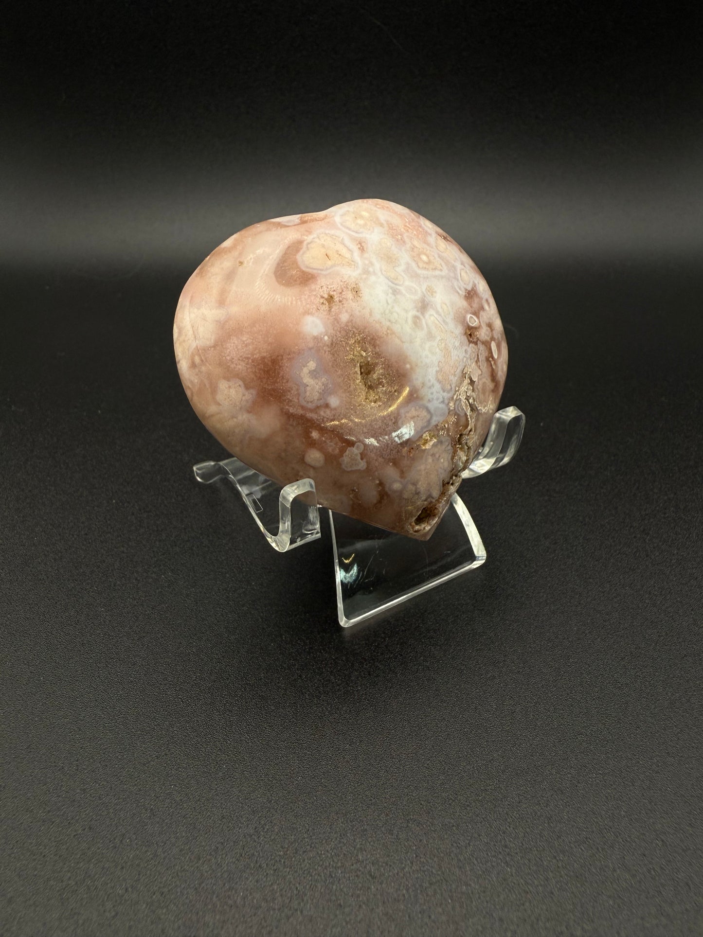 Flower agate polished crystal in the shape of a heart.