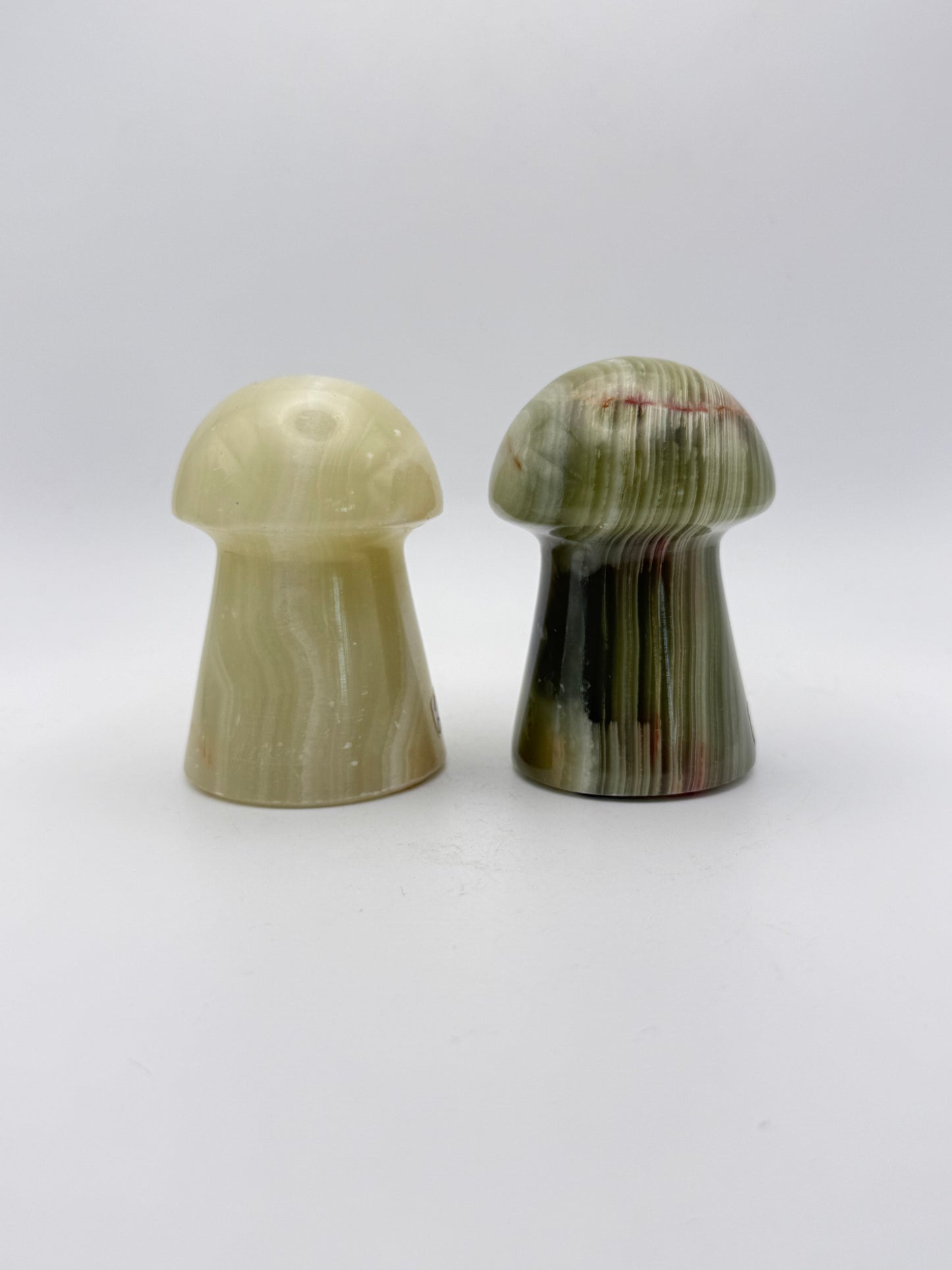 Two onyx mushroom-shaped stones.