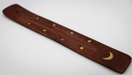 Incense burner with moon and star designs.