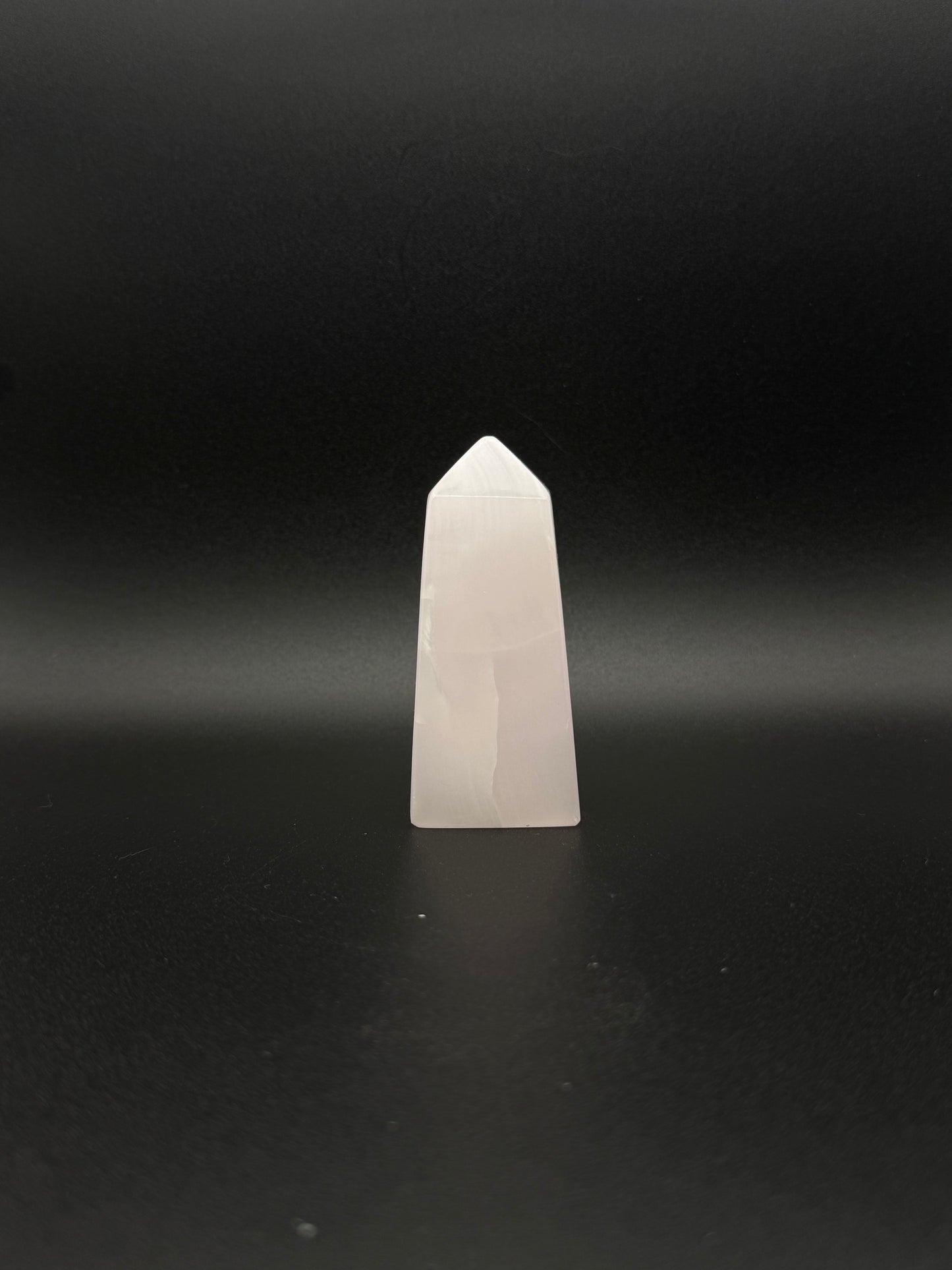 Polished pink calcite tower. Pink calcite glows under uv light.
