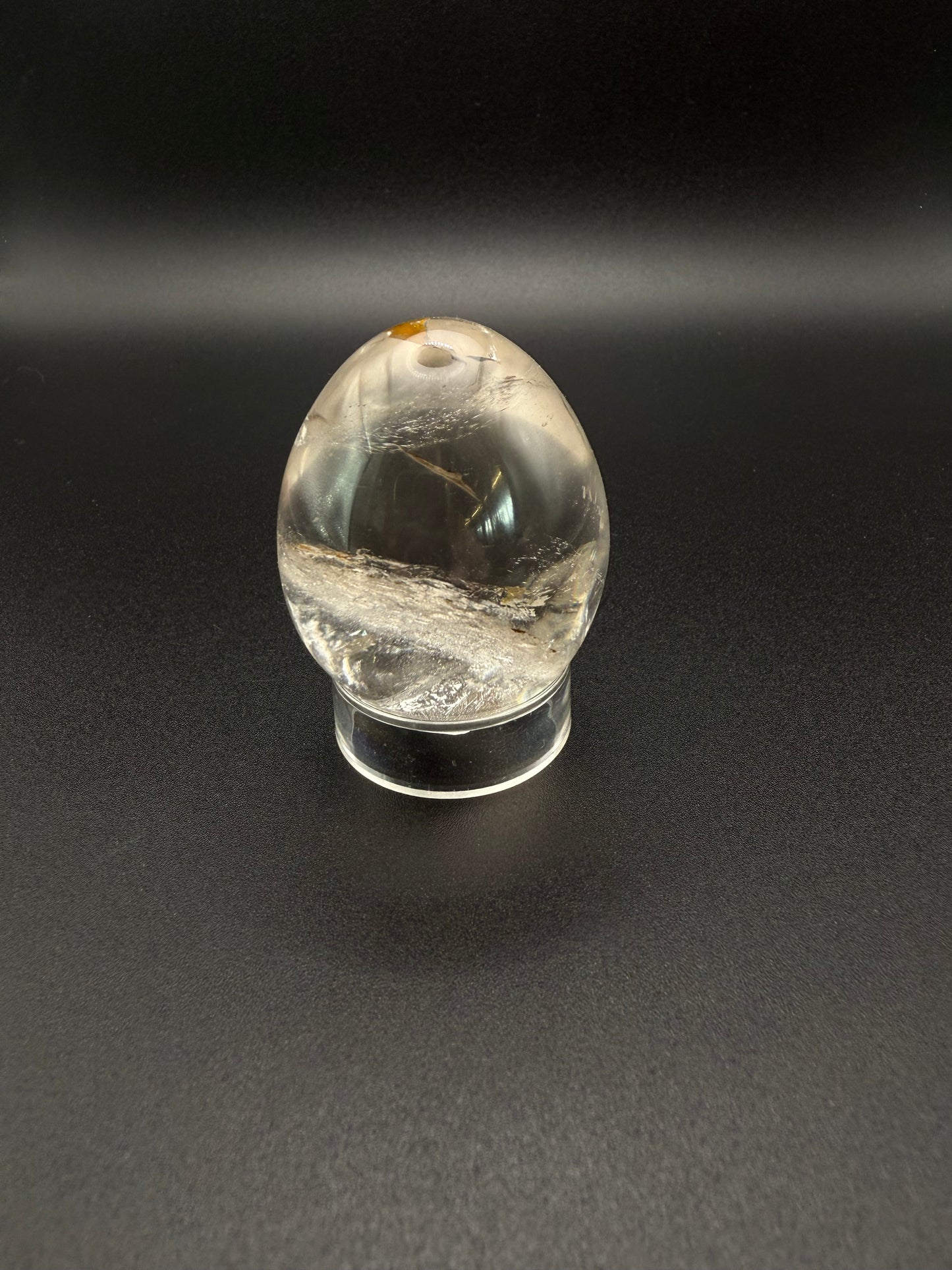 Clear quartz polished crystal thats egg shaped.