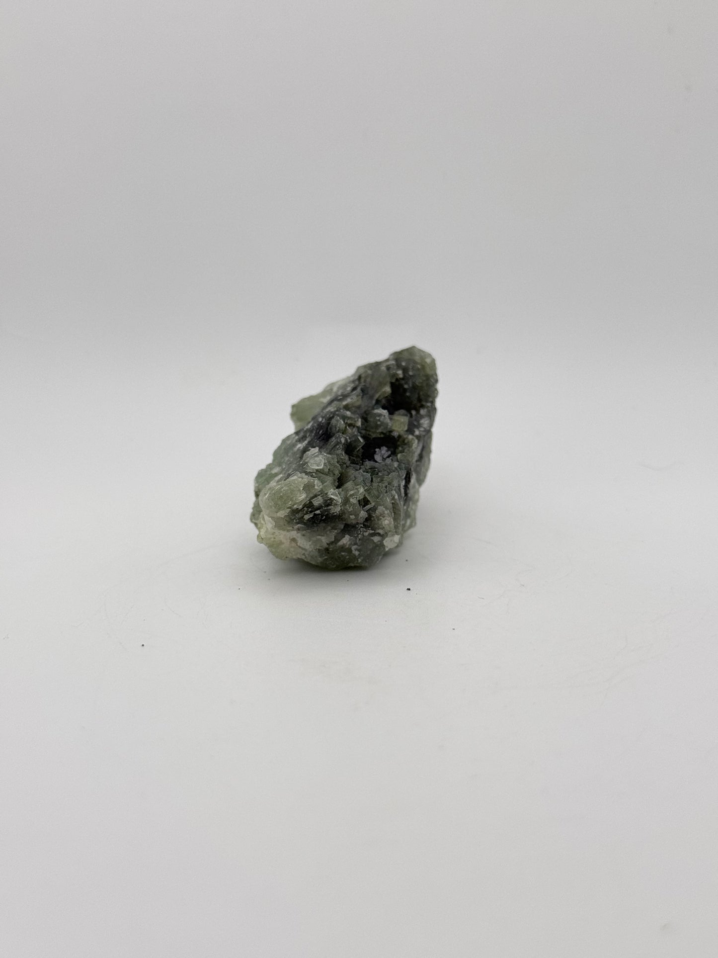 Raw Prehnite specimen with amazing green color.