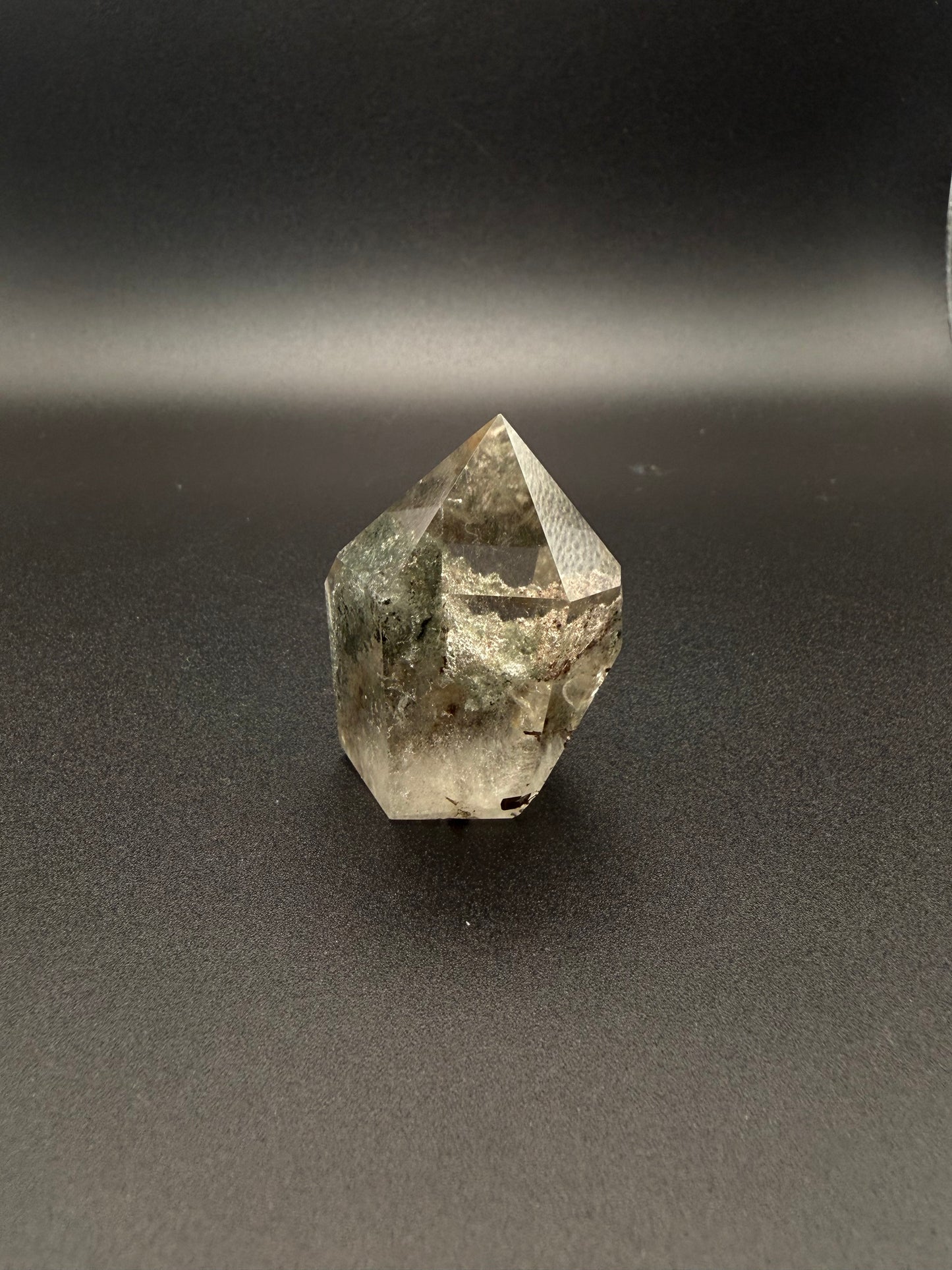 Polished garden quartz crystal tower with six sides.