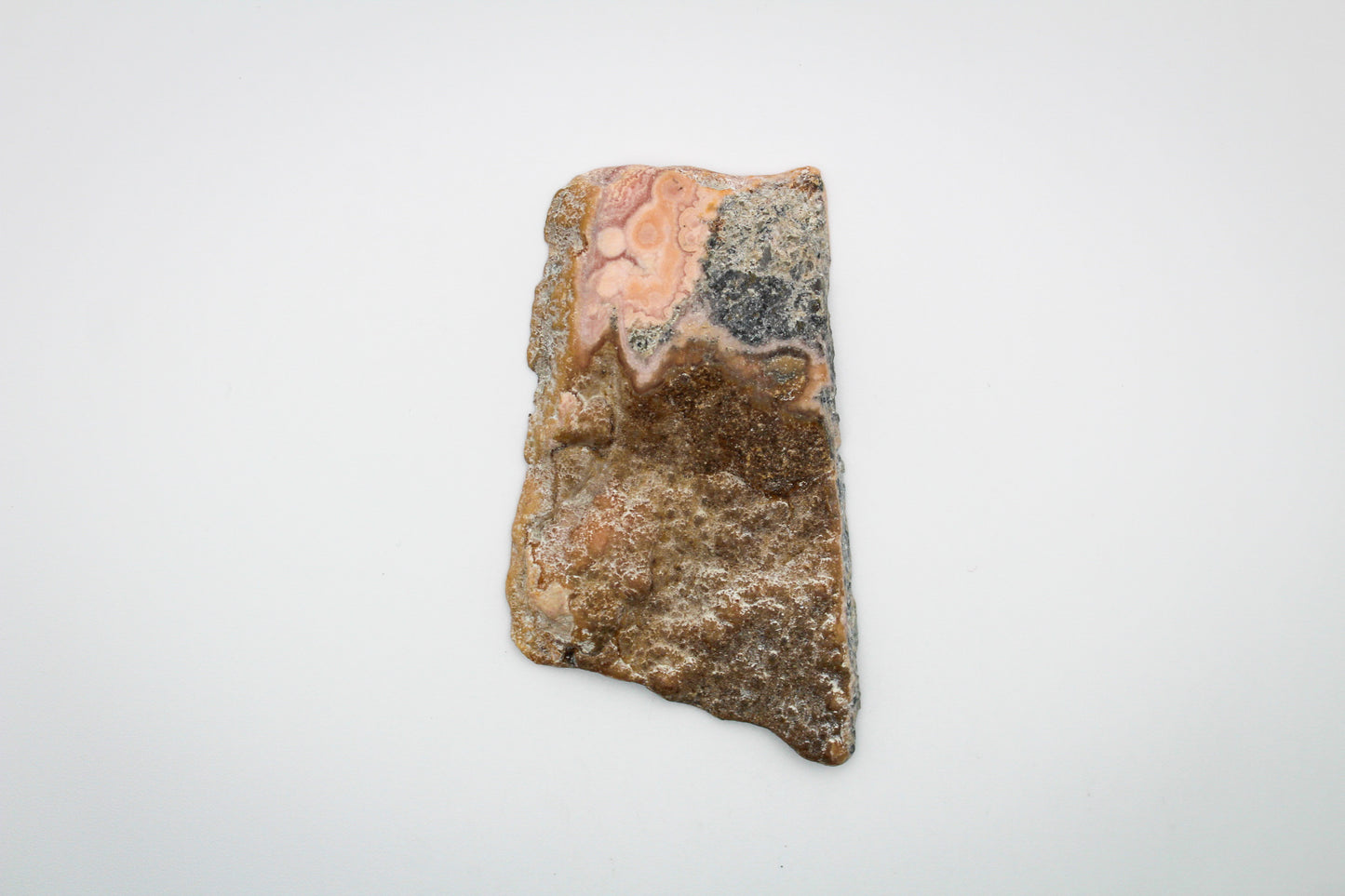 A polished rhodochrosite crystal slice.