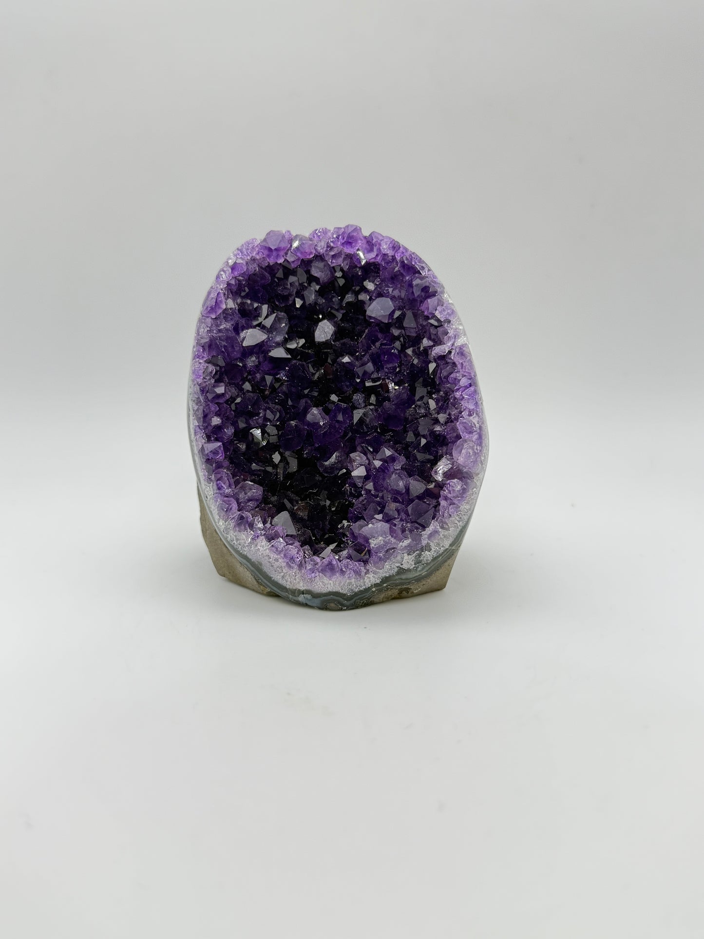 standing Amethyst cluster with deep purple crystals. about 3 1/2inches tall.