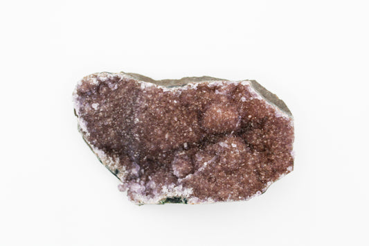 A rough, unpolished cluster of amethyst stones with a deep purple color and natural textures.