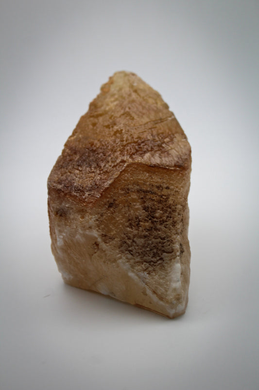 Raw dog tooth calcite crystal.