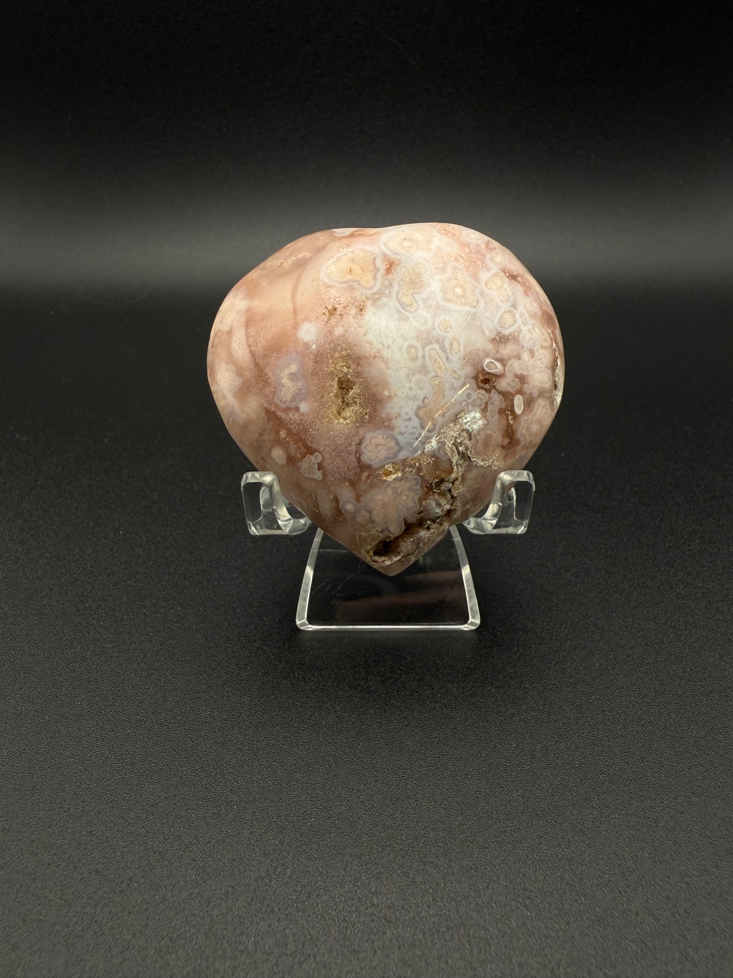 Flower agate polished crystal in the shape of a heart.