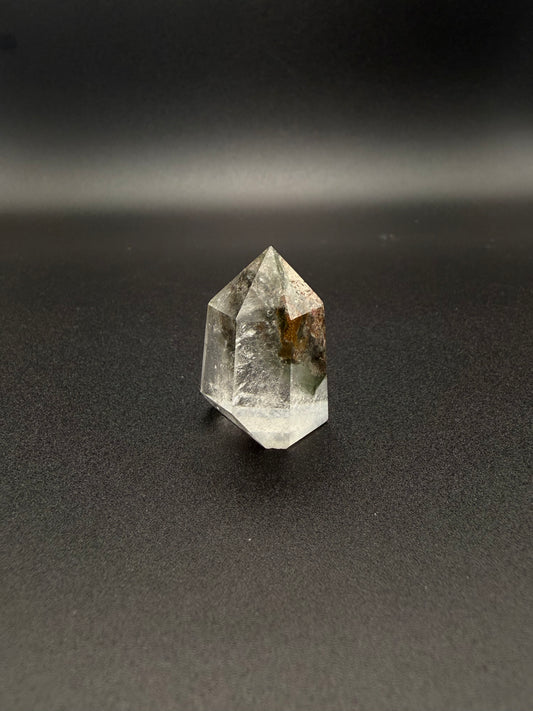 Polished garden quartz crystal tower with six sides.