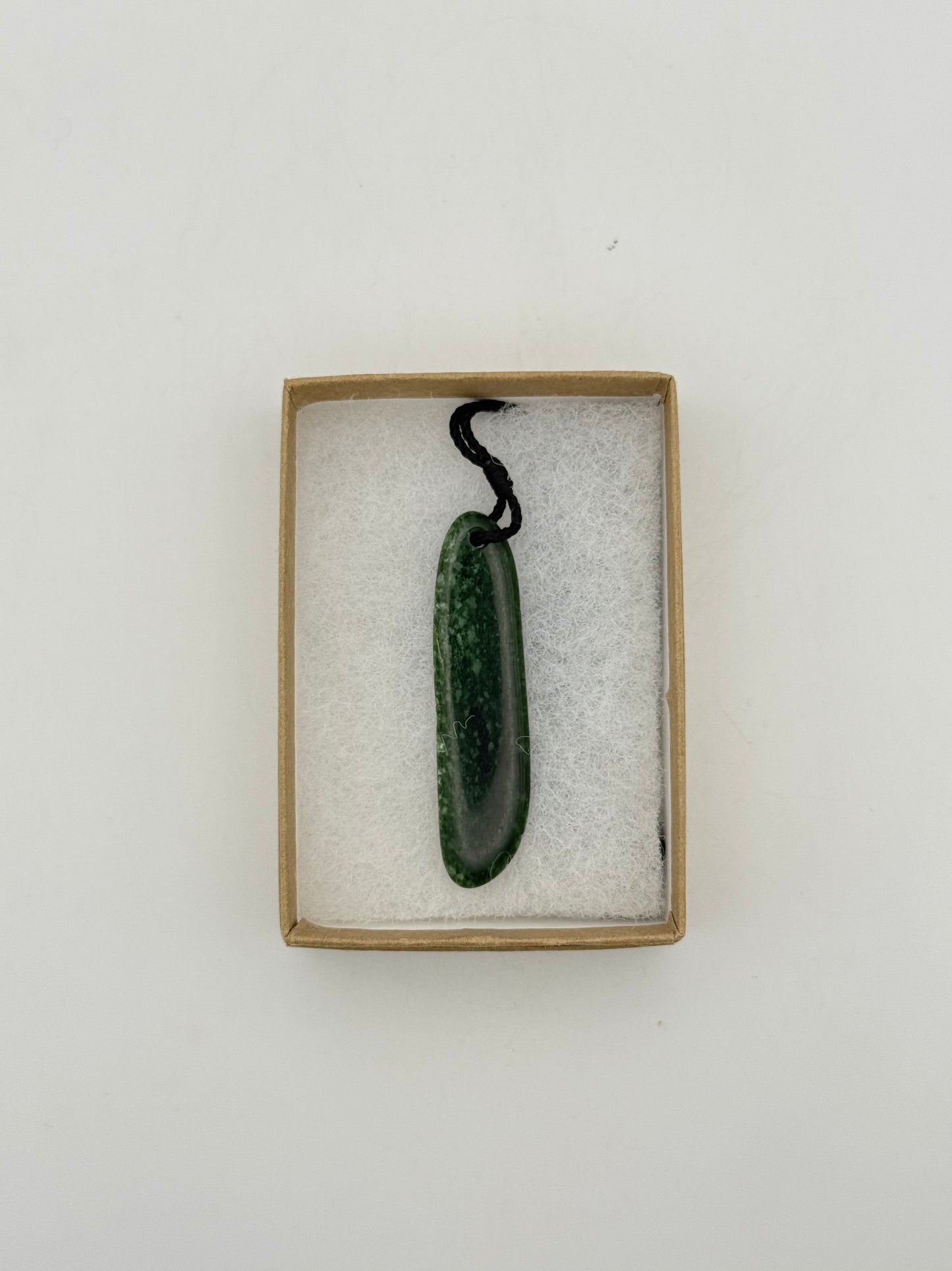 Green Jade pendant with string necklace.