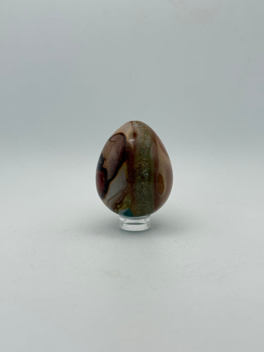 Polished polychrome jasper shaped into an egg.