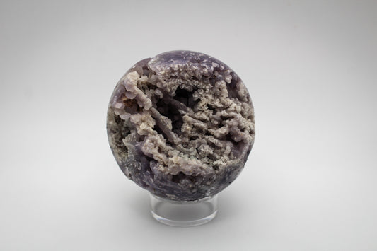 A spherical grape agate stone with a varied color pattern.