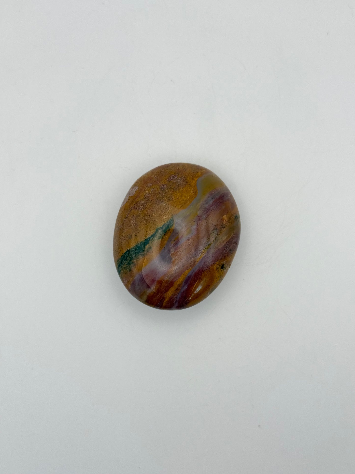 Polished ocean jasper palm stone.