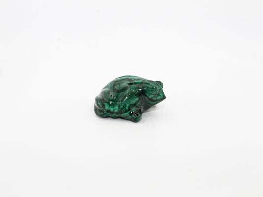 A small malachite stone formed into the shape of a frog.