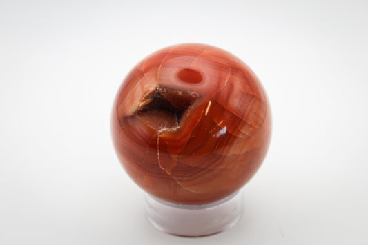 Carnelian polished crystal in a sphere shape.