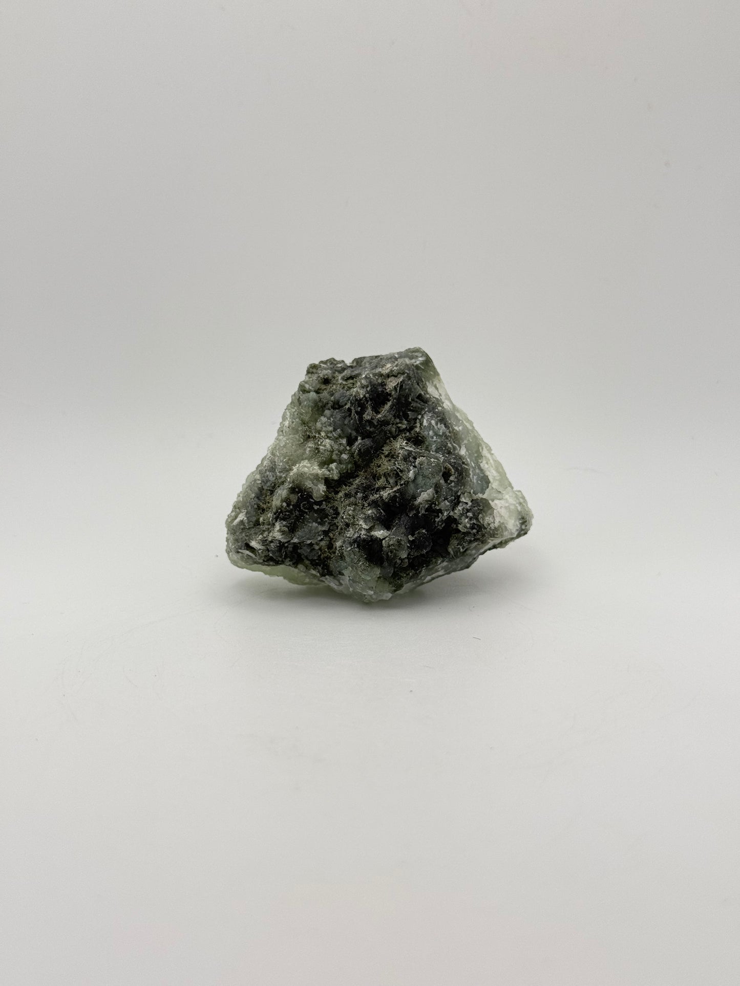 Raw Prehnite specimen with amazing green color.