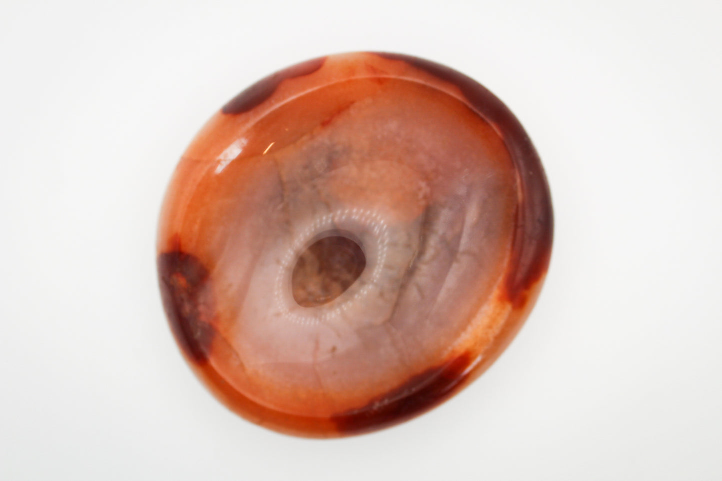 Polished carnelian crystal shaped into a bowl.