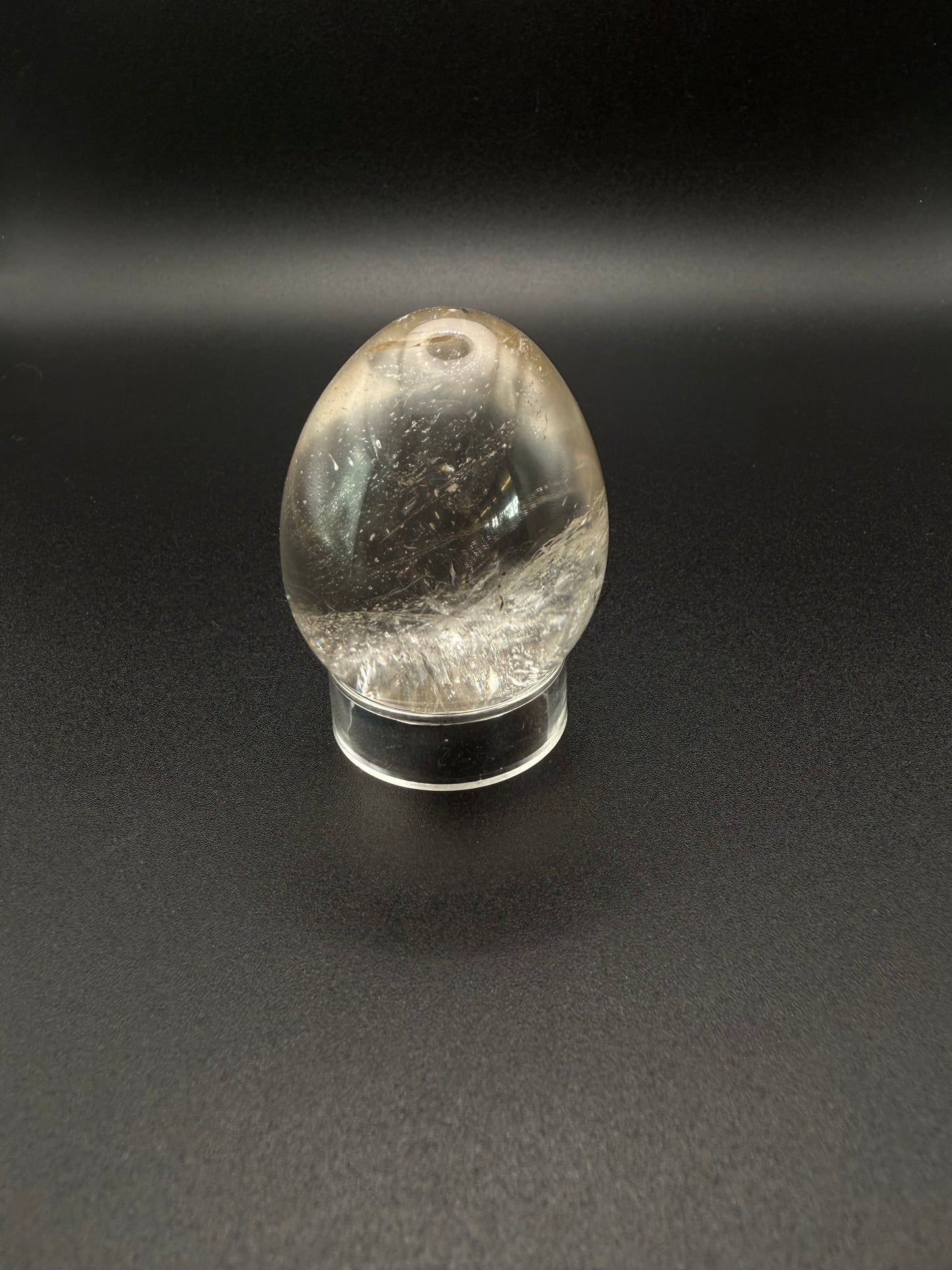 Clear quartz polished crystal thats egg shaped.