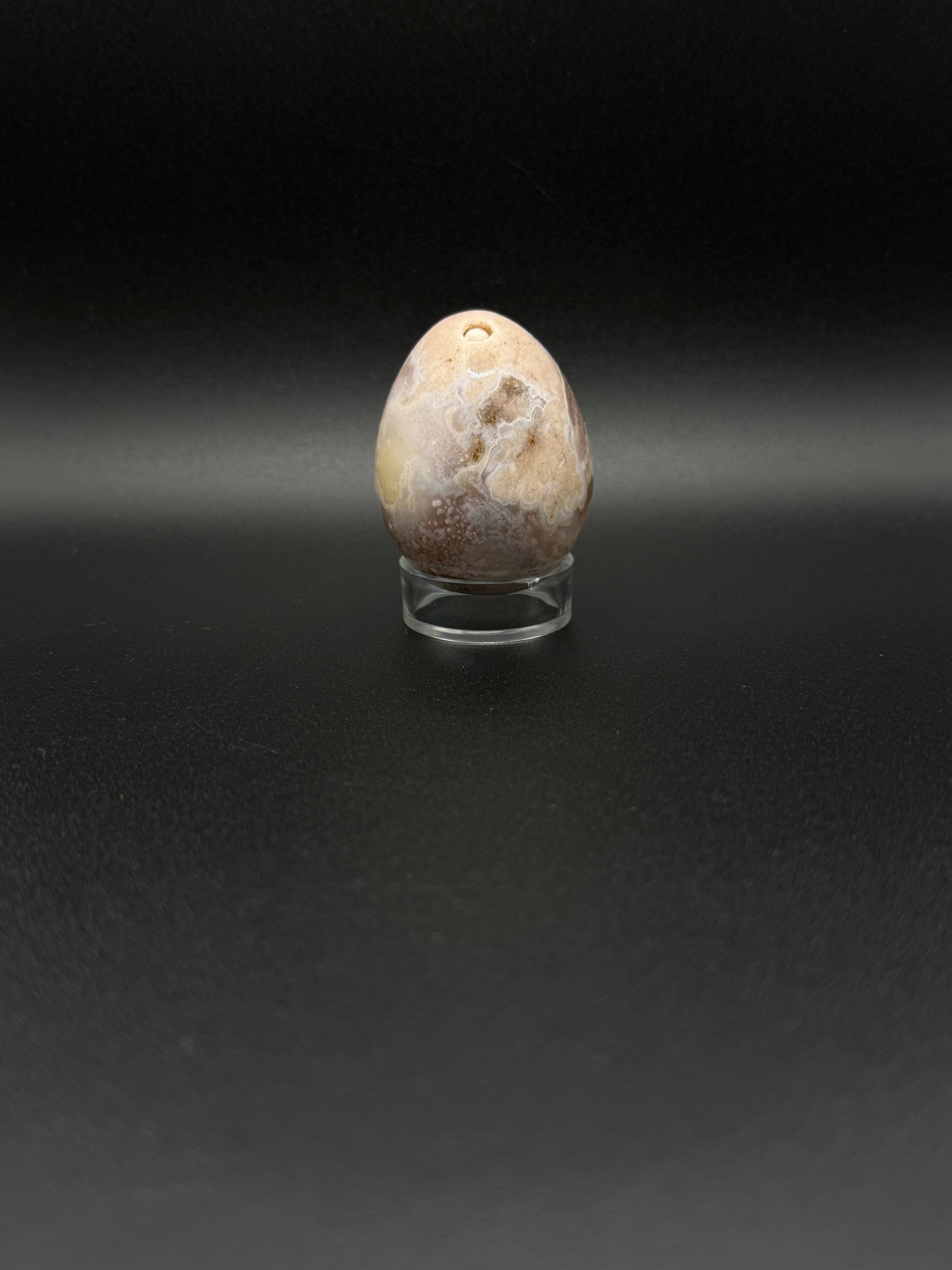 Polished flower agate crystal in the shape of an egg.