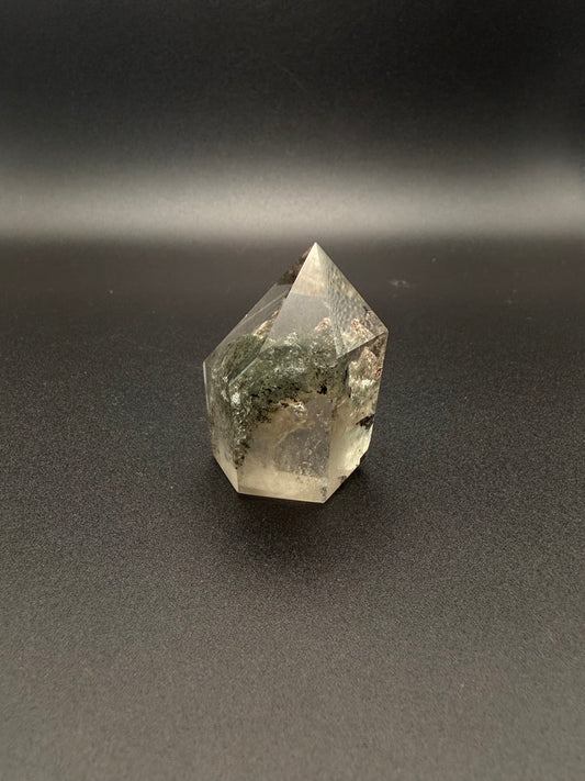 Polished garden quartz crystal tower with six sides.