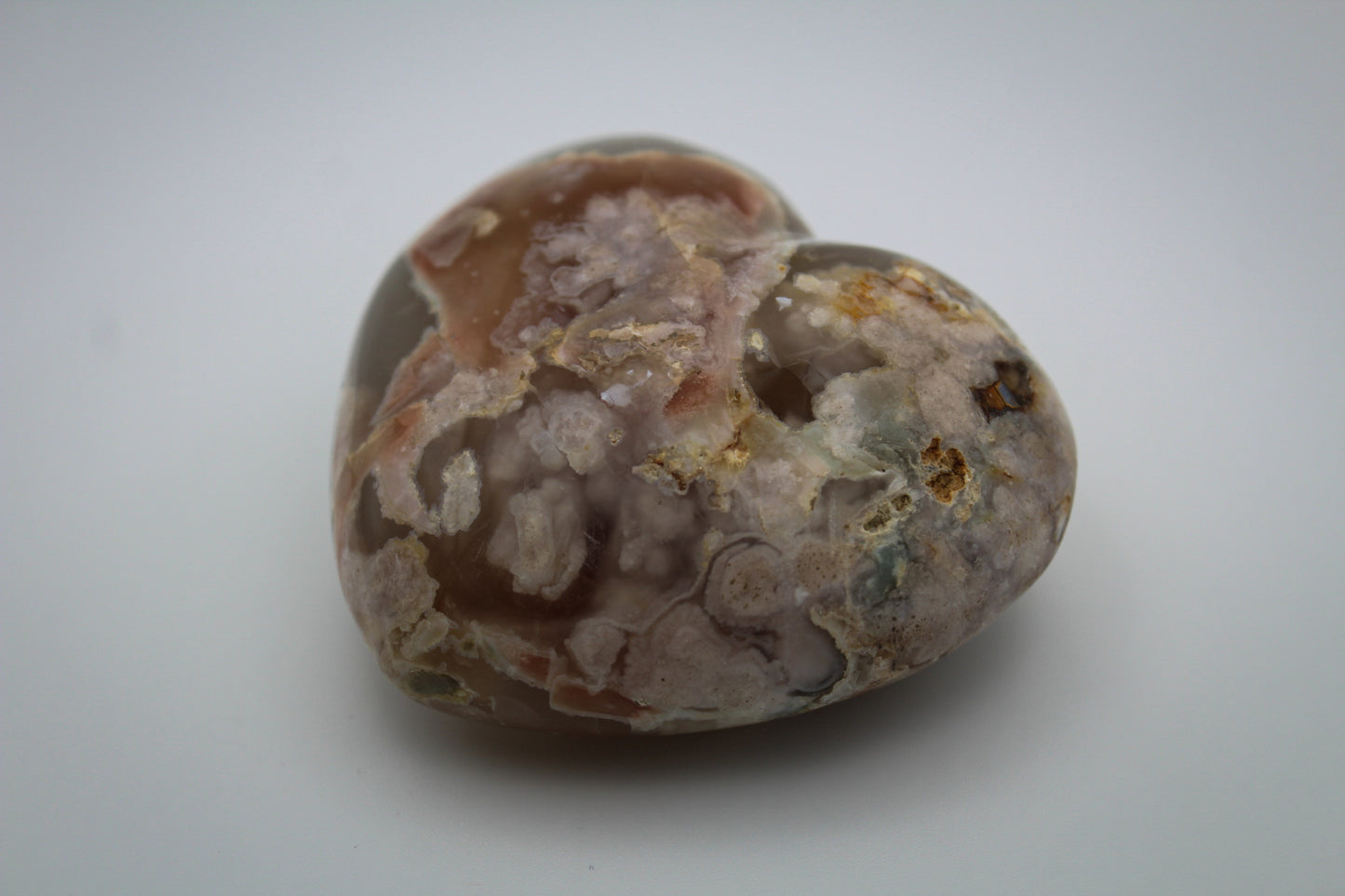 Polished flower agate in the shape of a heart.