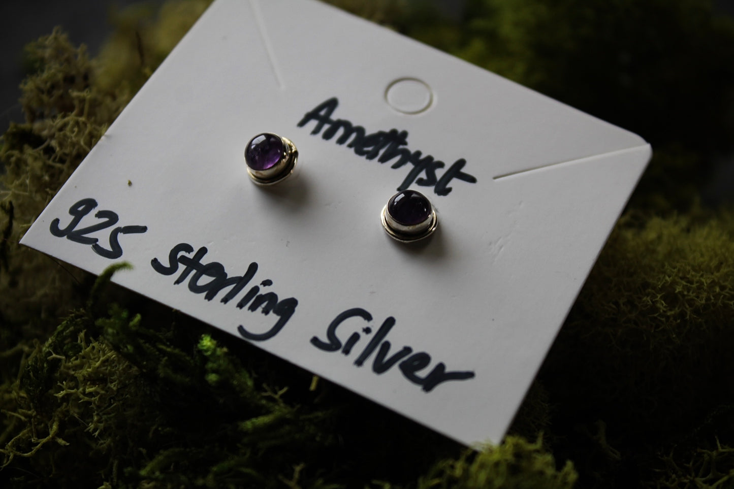 A pair of amethyst stud earrings in sterling silver.