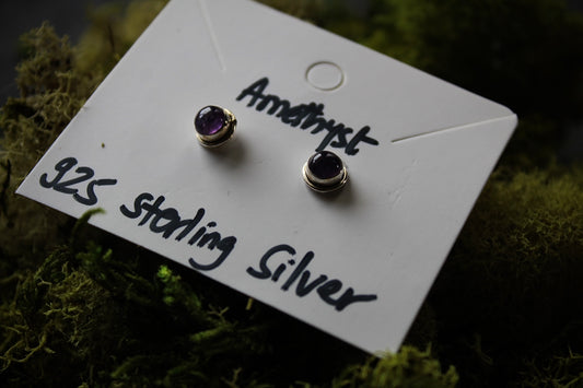 A pair of amethyst stud earrings in sterling silver.