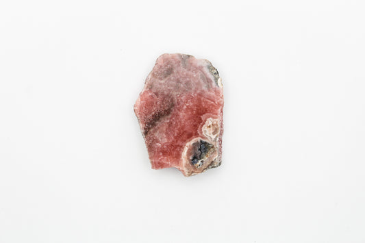A polished rhodochrosite crystal slice.