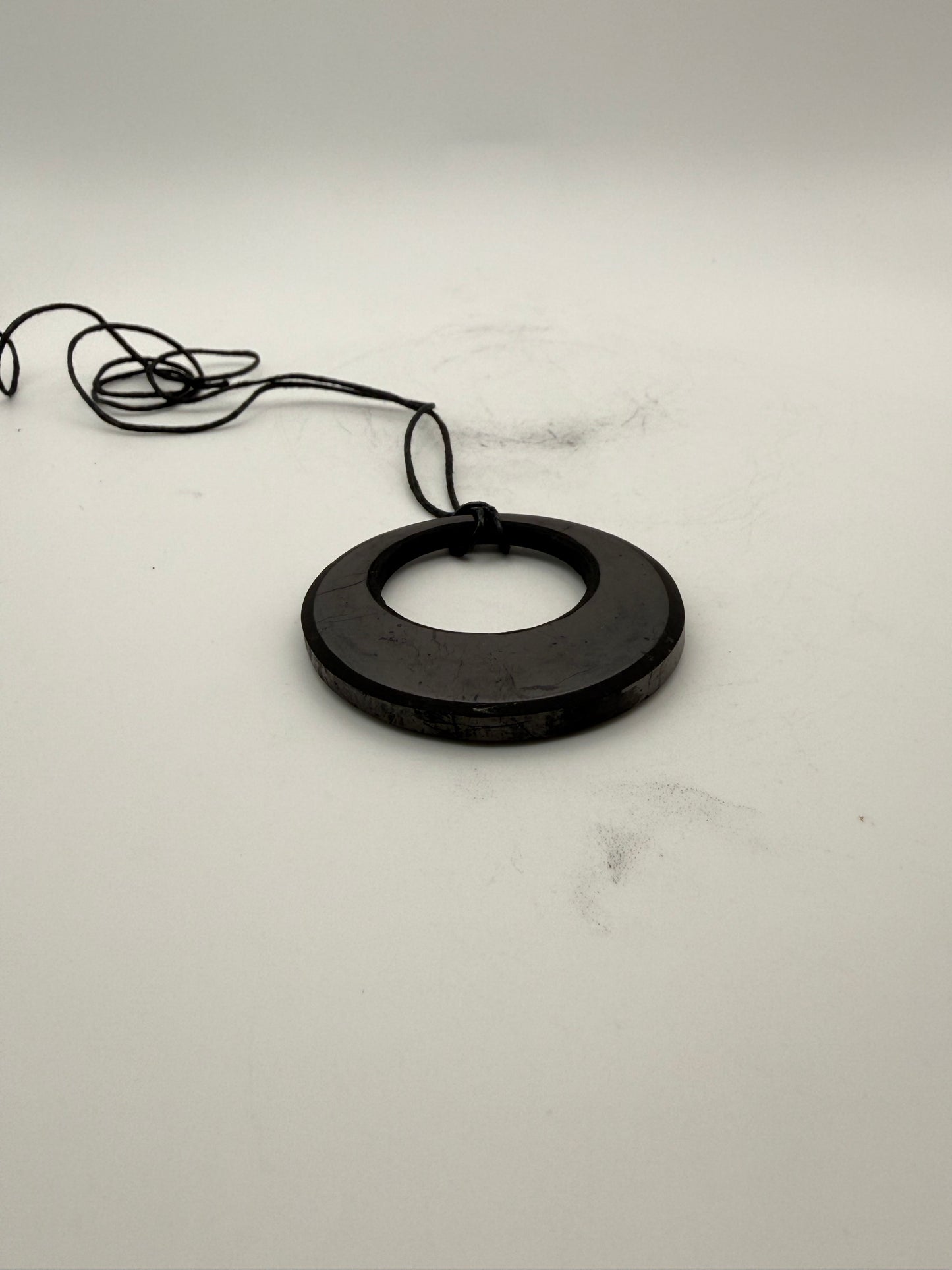 Shungite circle in circle pendant.
