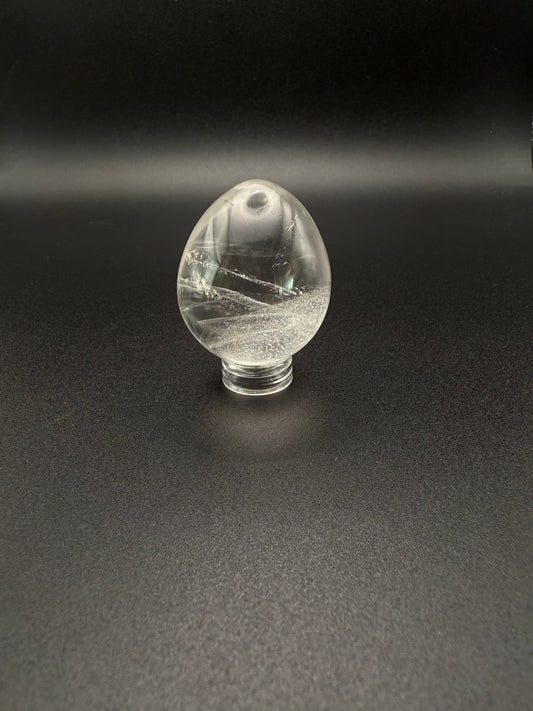 Clear quartz polished crystal in the shape of an egg.