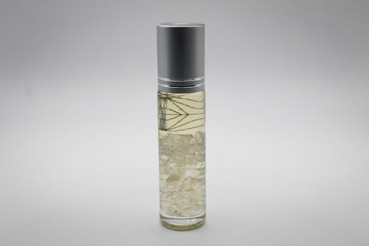 Roll on bottle with essential oils and crystals inside, with a manifest intention.