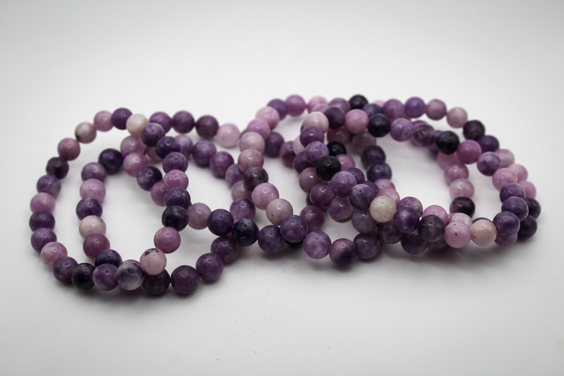 A bracelet made of purple lepidolite gemstone beads that are 8mm.