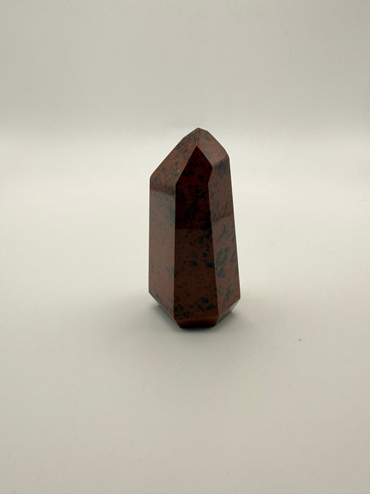 Polished mahogany obsidian tower with six sides.