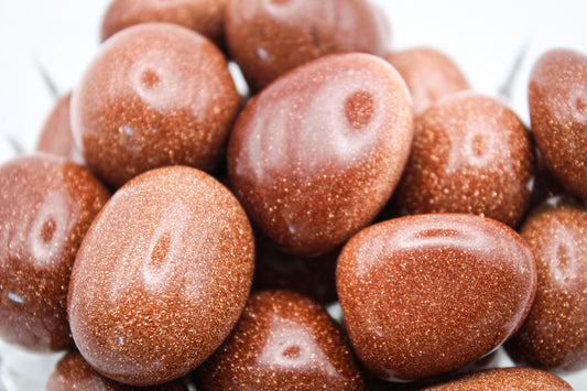 A close-up of polished goldstone tumbles.