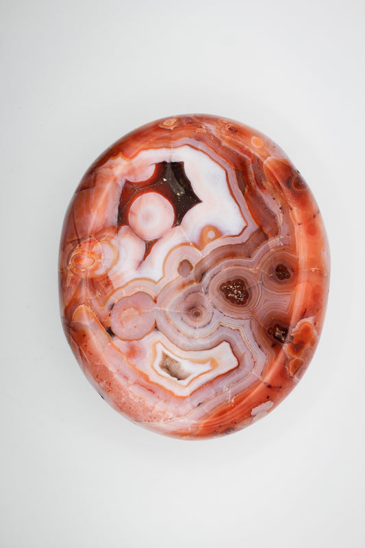 Polished carnelian crystal shaped into a bowl.