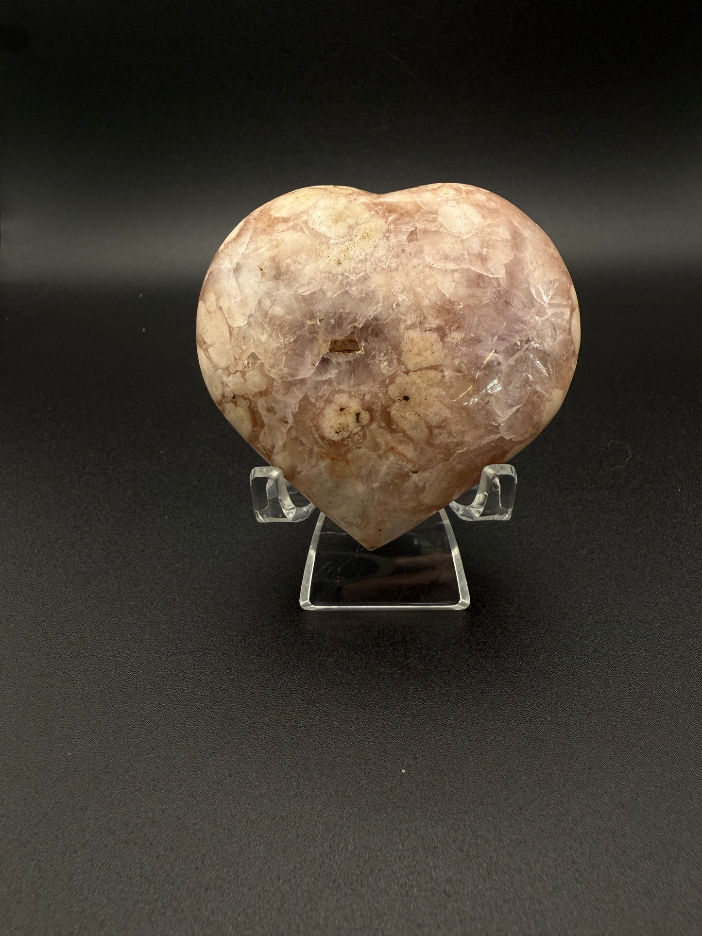 Flower agate polished crystal in the shape of a heart.