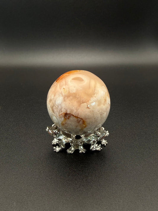 Flower agate polished crystal in the shape of a sphere.