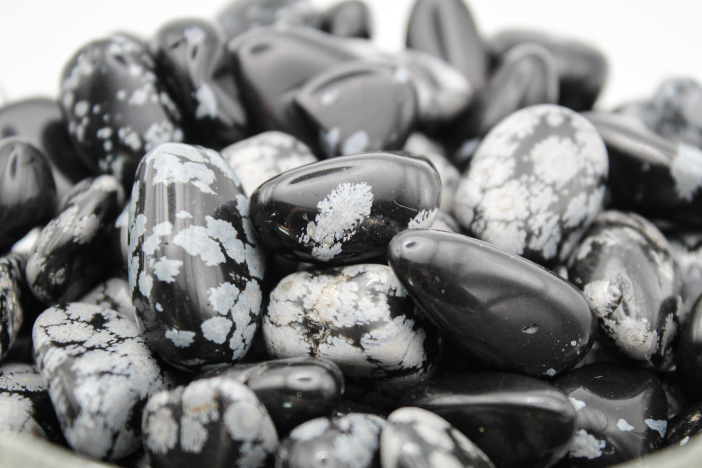 Black snowflake obsidian tumbles.