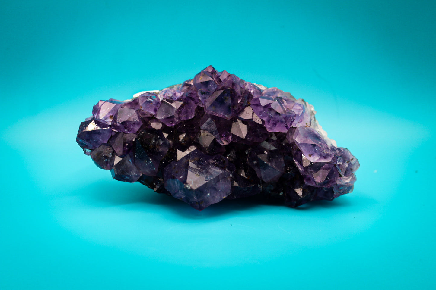 A cluster of amethyst crystals with a deep purple color.