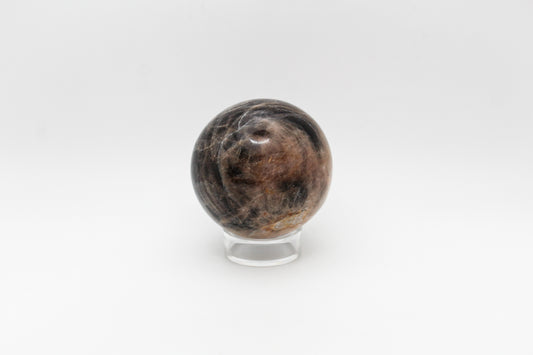 A polished black moonstone sphere.